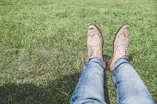 shoes person wearing blue jeans and pair of white shoes footwear