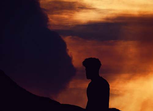 person silhouette photo of man near body of water human