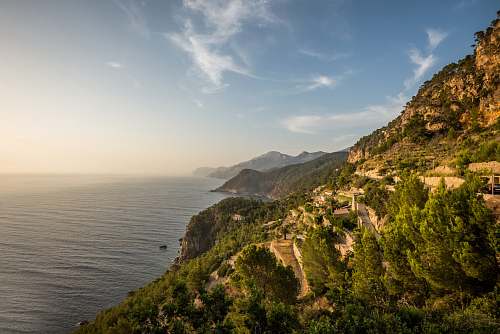 landscape mountain near body of water under blue sky sea