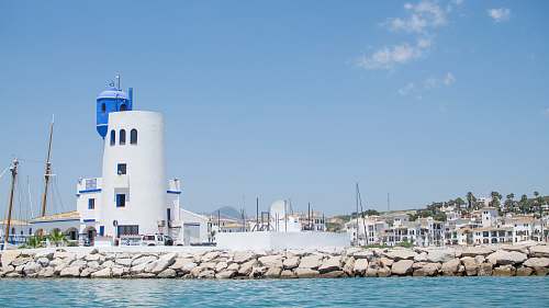 blue white tower along body of water water