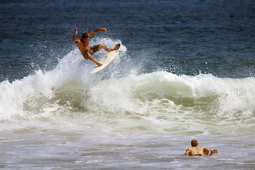 surfing man surfboarding on ocean wave during daytime surf