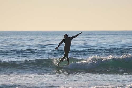 person man surfing during daytime ocean
