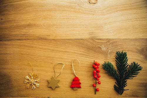 christmas five assorted Christmas tree decors on brown wooden surface foliage