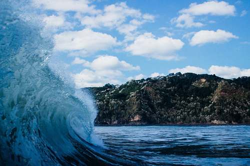 ocean close-up photography of sea wave under white clouds and blue sky sea