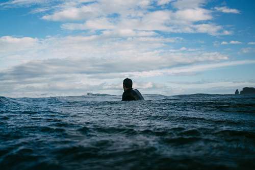 ocean man swimming during day time sea
