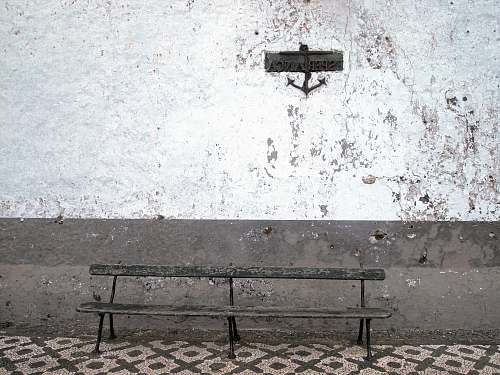 bench brown steel bench beside wall old bench