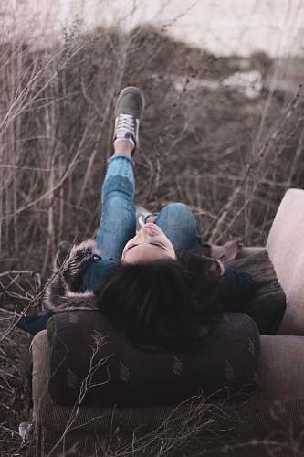 grey woman sitting lying on sofa chair couch