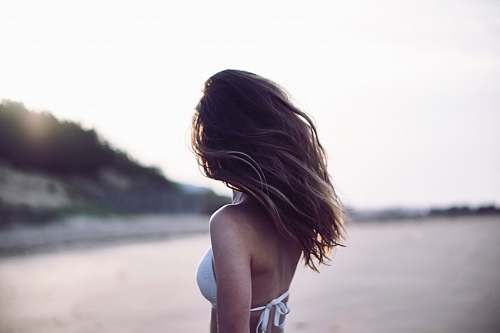 girl woman standing wearing white bra in selective focus photography hair
