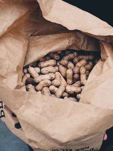 bag brown peanuts in brown opened paper bag sack