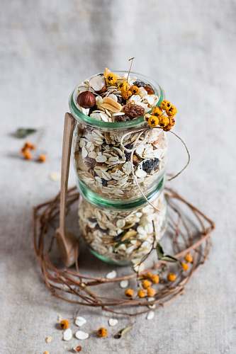 oats clear glass bottle on gray textile muesli