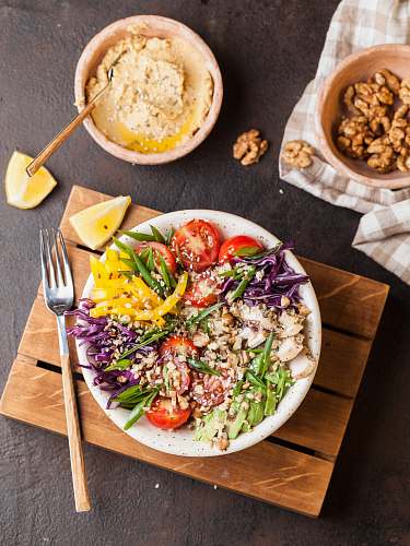 vegetable plate full of salad with spice on top of brown board produce
