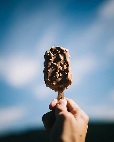 person person holding popsicle people