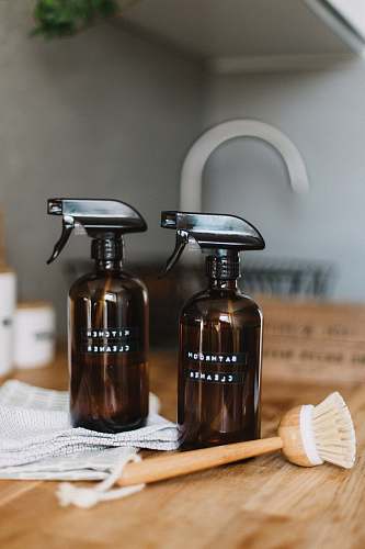 clean two brown spray bottles on brown table home