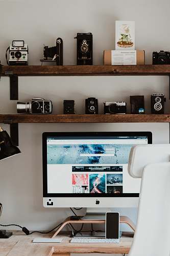 electronics black flat screen computer monitor on brown wooden desk furniture