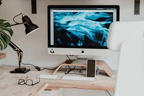 electronics silver imac on brown wooden desk monitor