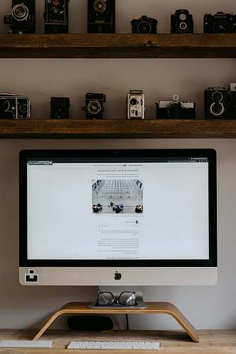 electronics silver imac on brown wooden table monitor
