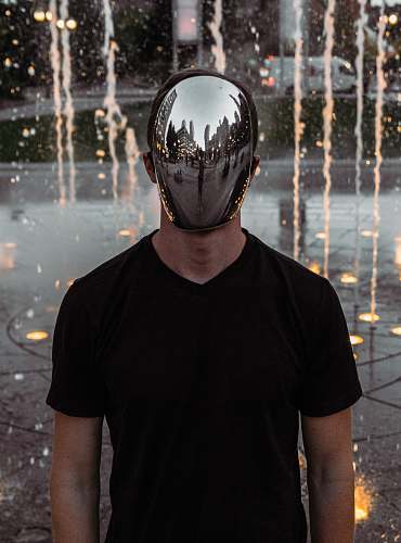 human man covering his face standing person