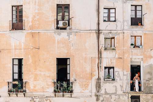 city minimalist photography of open windows and doors of building terraces italy