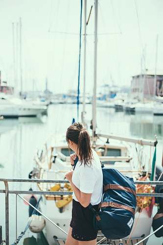 transportation woman wearing white shirt holding blue duffel bag vessel