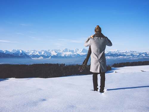 apparel woman standing near trees and body of water \ switzerland