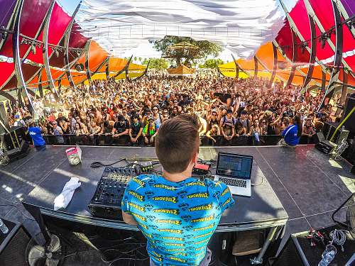 music DJ on stage in front of audience festival