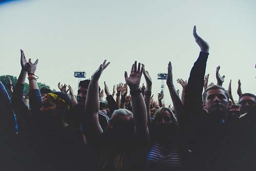 audience photography of people gathering near outdoor during daytime rock