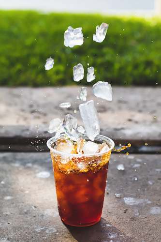 beverage macro photography of dropping ice cube in cup cocktail