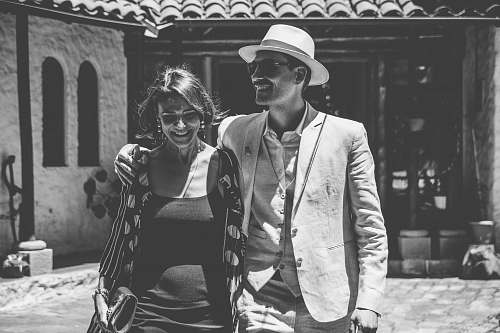 grey man and woman laughing together black-and-white