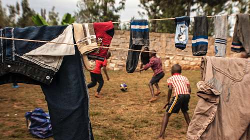 person two boys playing under clothesline kenya
