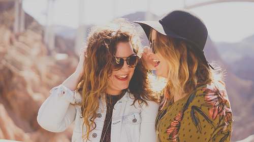 woman two women smiling while wearing sunglasses people