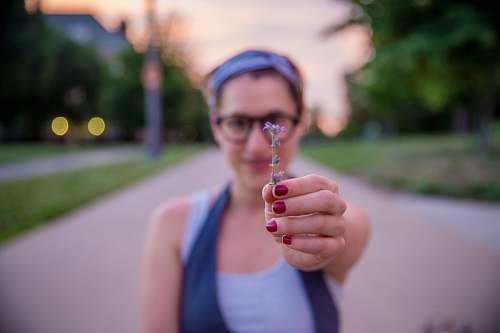 person woman holding purple flower girl