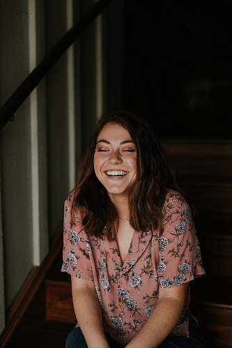 people woman sitting on wooden stair smiling person