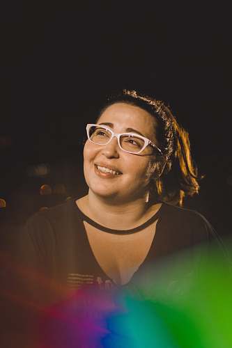 people woman smiling while taking photo during nighttime person