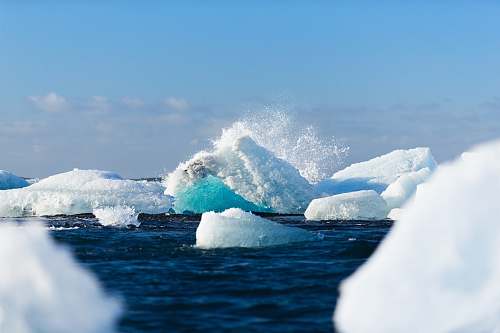 winter icebergs floating on body of water during daytime iceberg