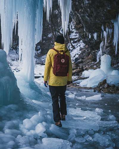 outdoors man carrying red backpack nature
