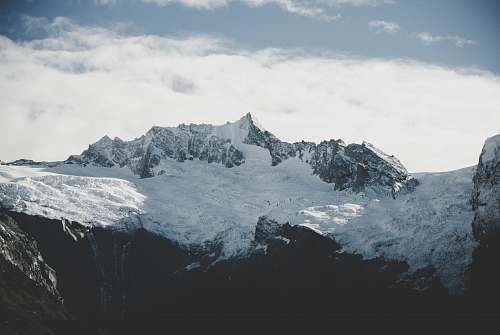 mountain mountains under snow during daytime glacier
