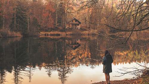 lake girl standing near to body of water reflection