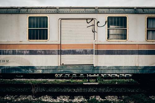 trieste white and orange train on railway train