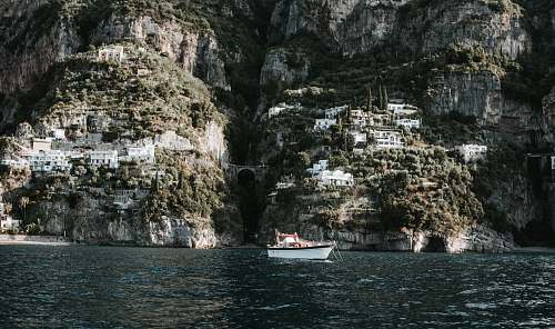 cliff white motorboat on body of water boat