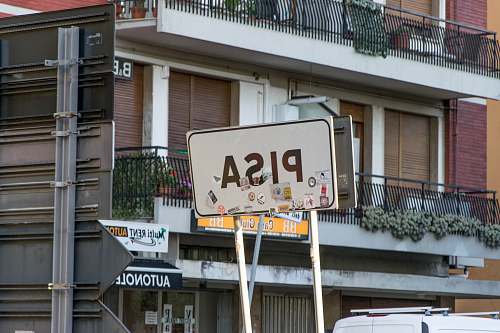 sign white PISA road signage near building pisa