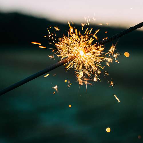 fireworks shallow focus photography of sparkler firework