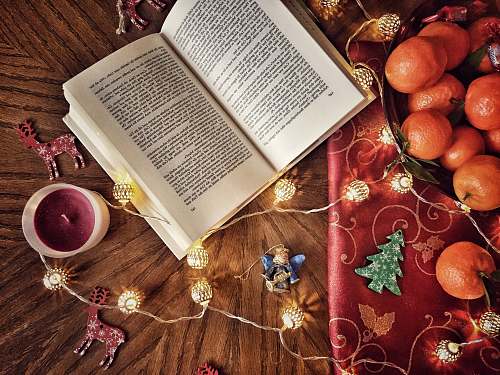 book opened book beside tealight christmas