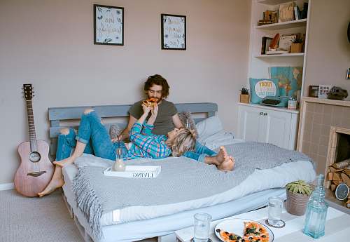 couple man and woman lying on bed furniture