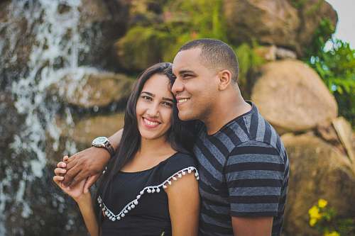 human man and woman taking picture while holding their hands person
