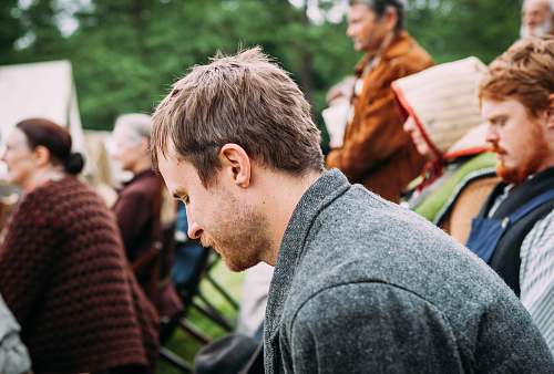 person man sitting on chair near people sitting on chair during daytime male