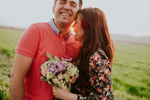 human smiling woman hugging smiling man during daytime couple