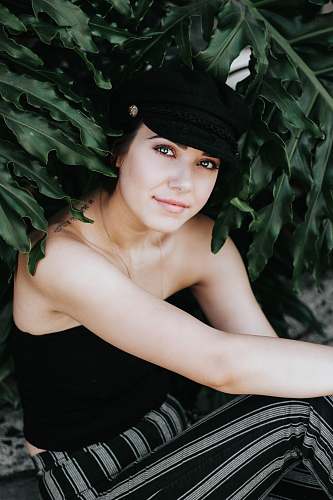 woman smiling woman in black strapless top and black and white striped pants human