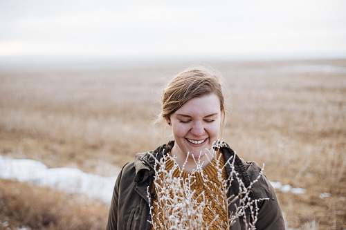 woman woman smiling near flower during faytime female