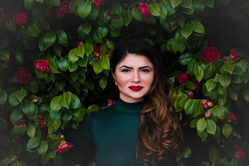woman woman standing near green tree brunette