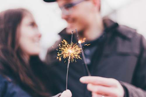 human man and woman holding fireworks people